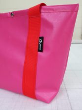 Closeup detailing of pink Iona Shopper Bag with red straps
