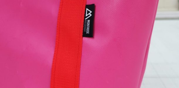 Closeup detailing of pink Iona Shopper Bag with red straps